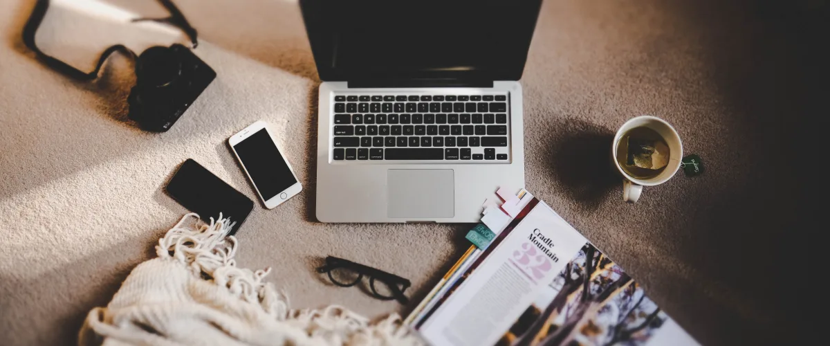 Custom travel itinerary planning with notebook, map, passport, and camera on an elegant table